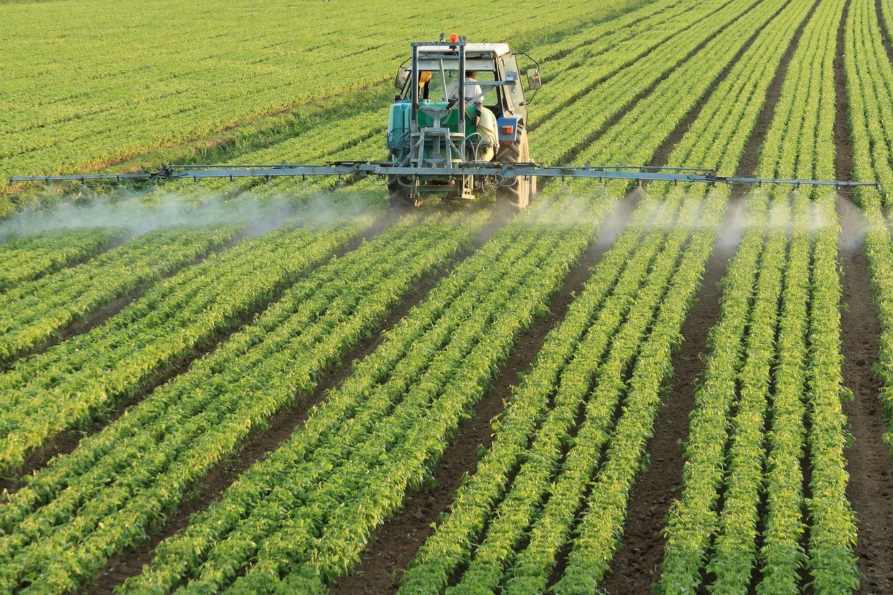 Tractor spraying a field